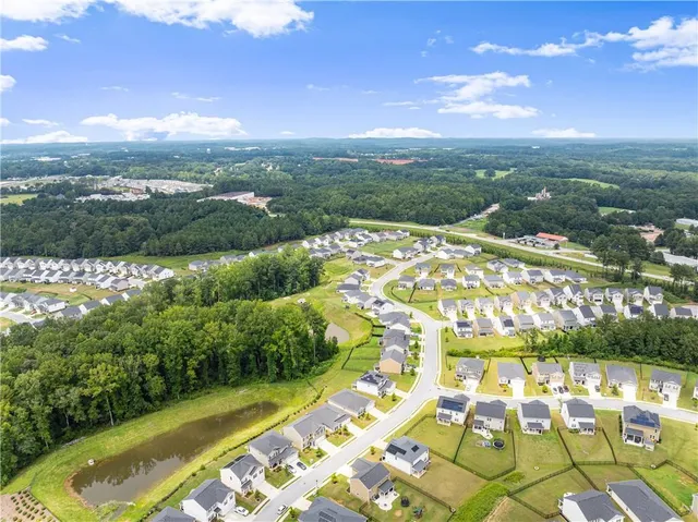 an aerial view of residential houses with outdoor space and swimming pool