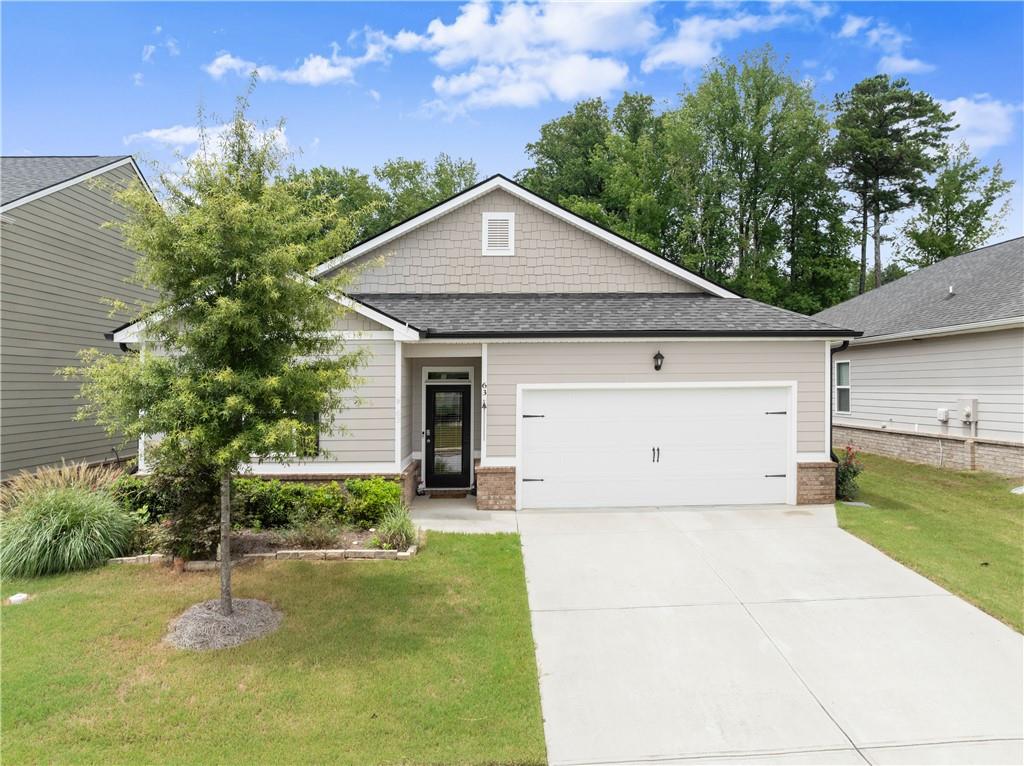 63 Conroe Court Hoschton, GA 30548 - Photo 4 of 44 a front view of a house with garden