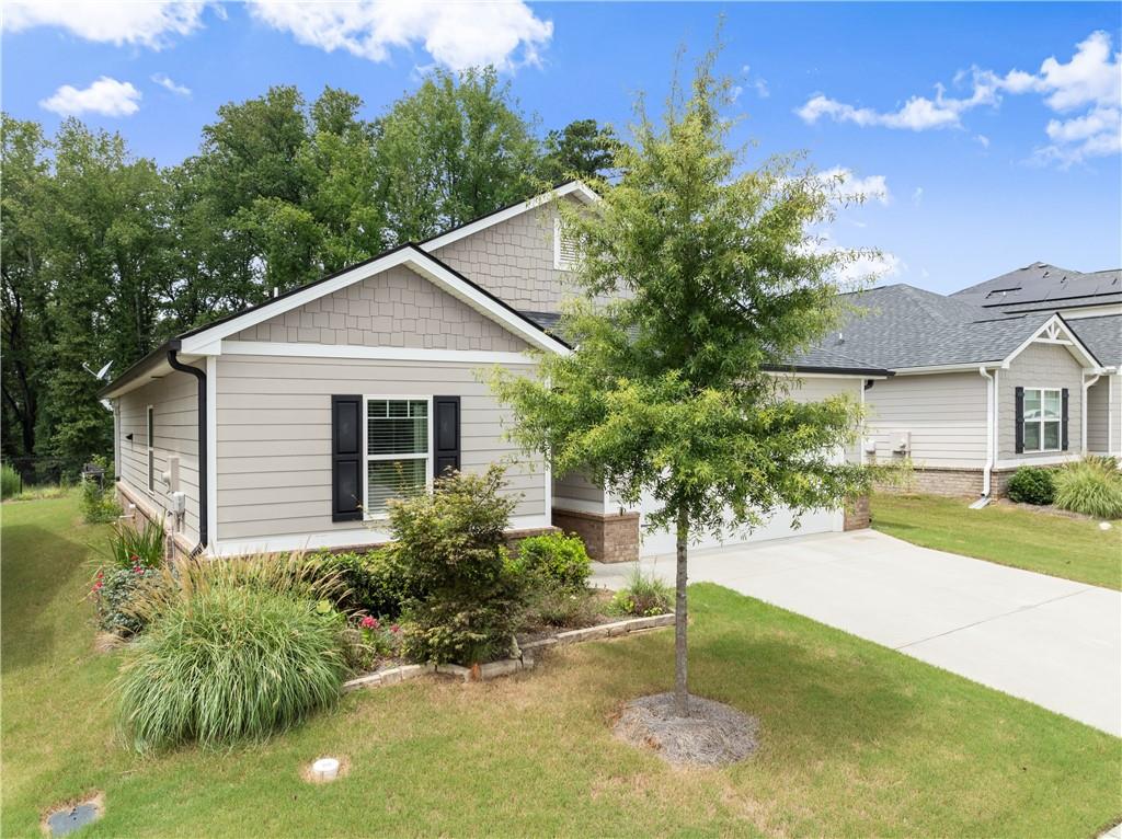 63 Conroe Court Hoschton, GA 30548 - Photo 5 of 44 a house view with a garden space