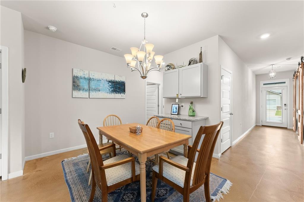 63 Conroe Court Hoschton, GA 30548 - Photo 7 of 44 a view of a dining room with furniture and wooden floor