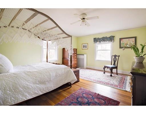 143 Windsor Road Newton, MA 02468 - Photo 7 of 9 a bedroom with a bed a chandelier and window
