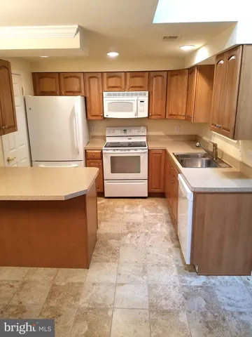 a kitchen with a refrigerator sink and stove