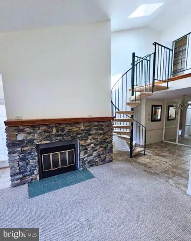 a view of a livingroom with furniture and staircase