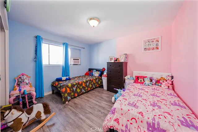 a bedroom with bed and wooden floor