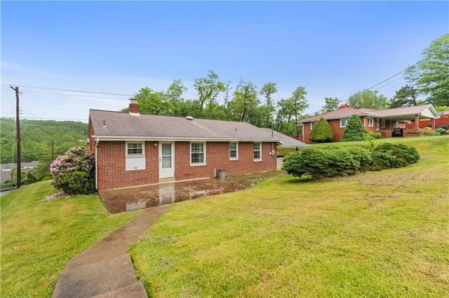 a front view of a house with a yard