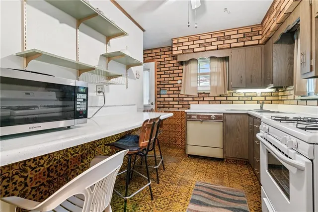 a kitchen with a stove a sink and a microwave