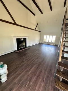 a view of a room with wooden floor and windows