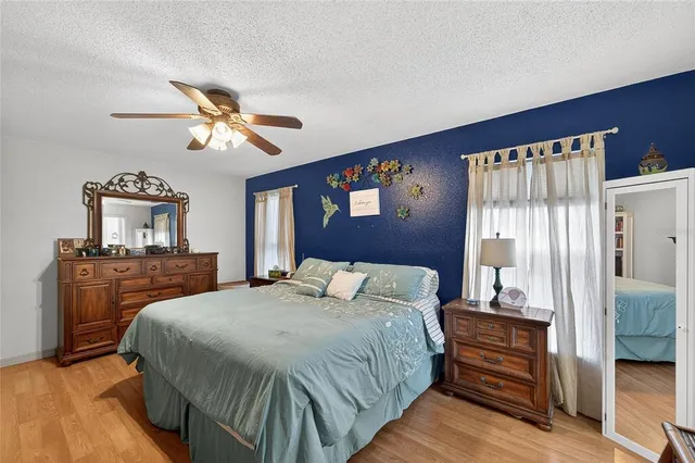 a bedroom with furniture and a flat screen tv