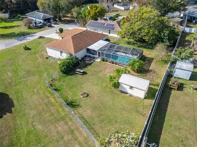 a view of a livingroom and a dining room with furniture wooden floor and a rug