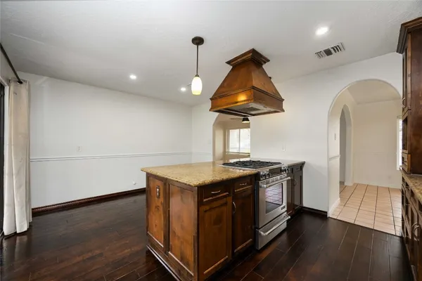 a kitchen with stainless steel appliances granite countertop a stove and a refrigerator