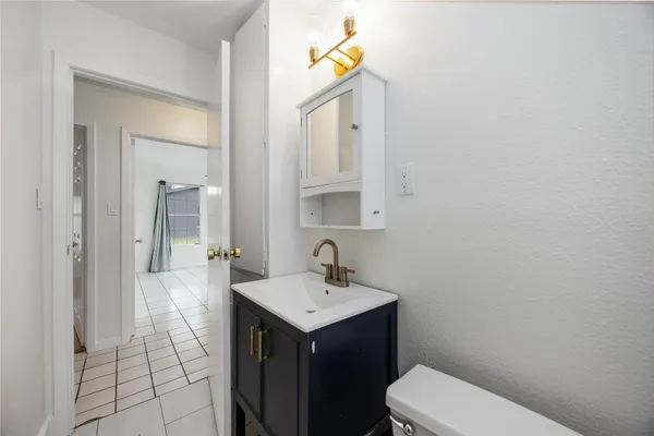 a bathroom with a sink a toilet and mirror