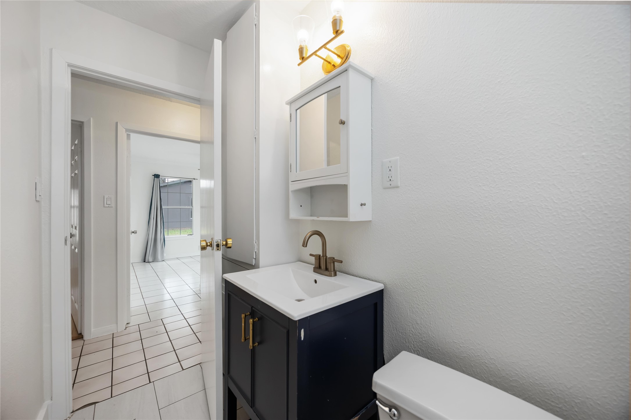 1721 Jones Street Rosenberg, TX 77471 - Photo 16 of 27 a bathroom with a sink a toilet and mirror