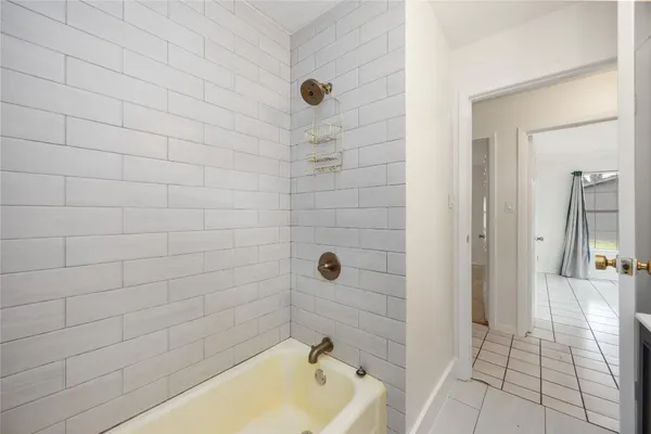 a bathroom with a tub and a shower