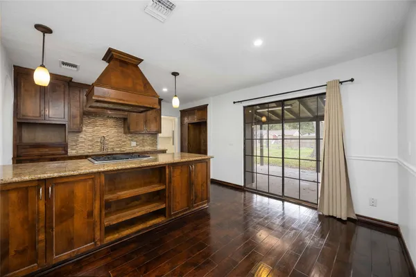a kitchen with stainless steel appliances granite countertop a stove a sink and a refrigerator