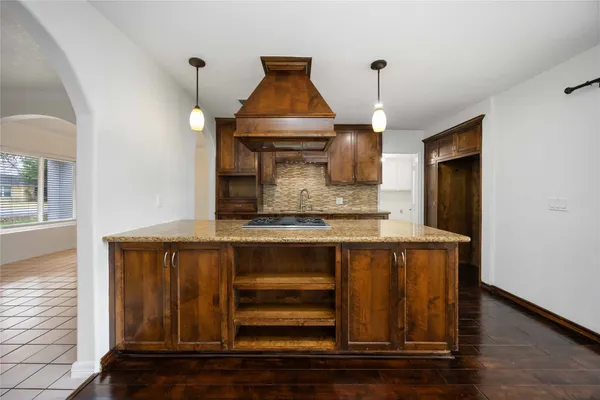 a kitchen with a sink a microwave and cabinets