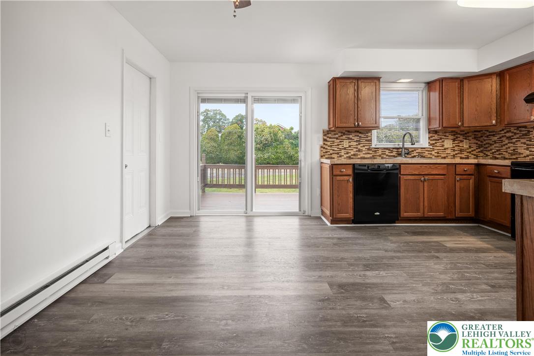 2735 Fairview Street Bethlehem, PA 18020 - Photo 11 of 43 a large kitchen with granite countertop a stove top oven a sink and dishwasher wooden cabinets with wooden floor