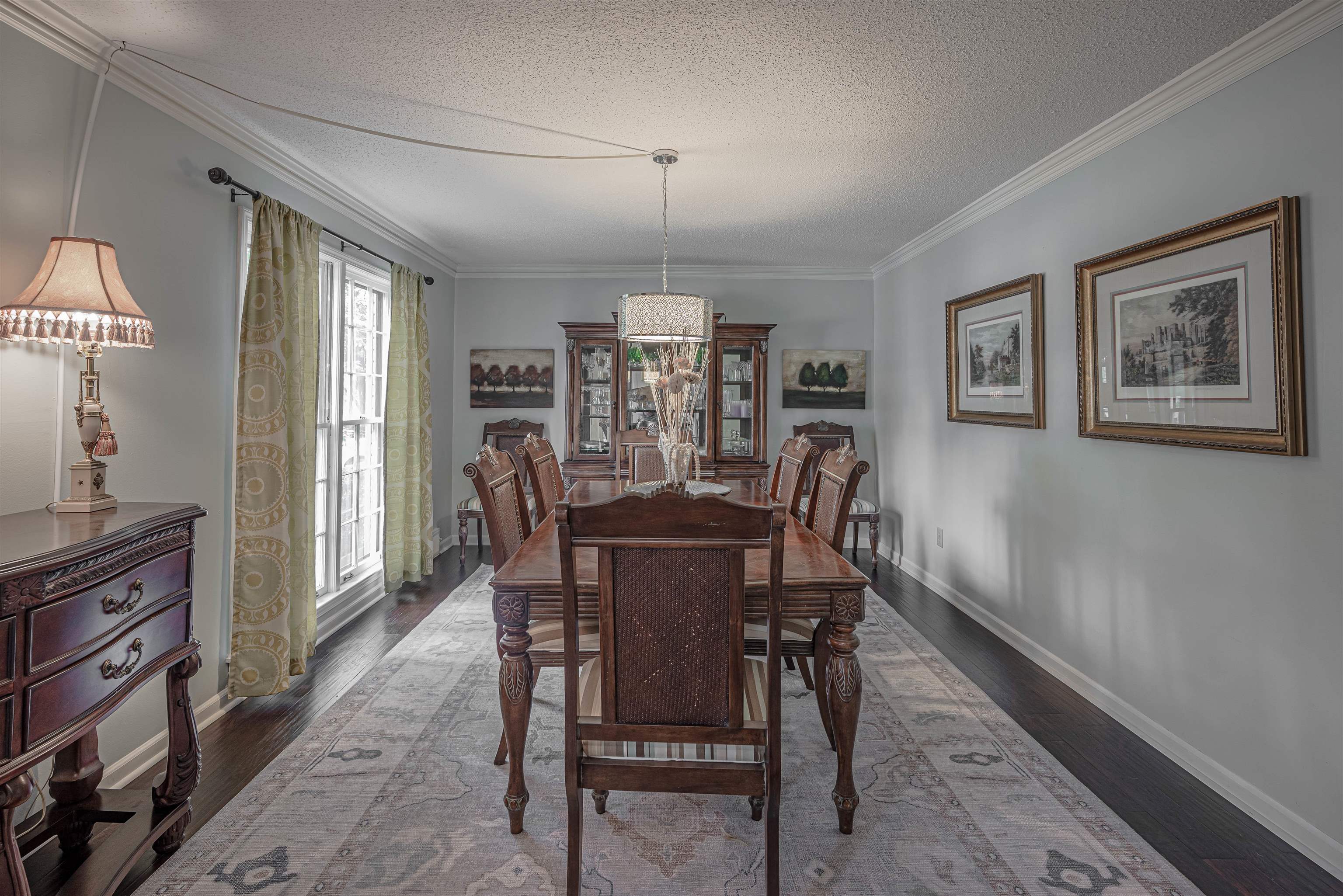 2006 Cordes Road Germantown, TN 38139 - Photo 5 of 36 Dining room featuring a textured ceiling, ornamental molding, and dark hardwood / wood-style flooring