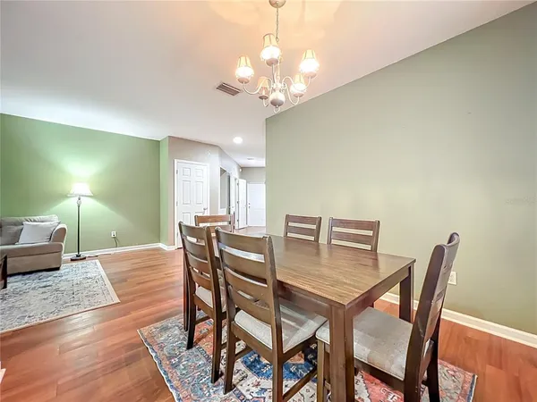 a view of a dining room with furniture and chandelier