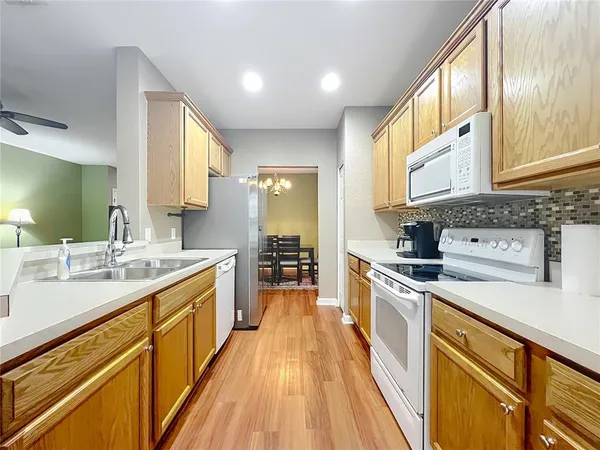 a kitchen with a sink stove and cabinets
