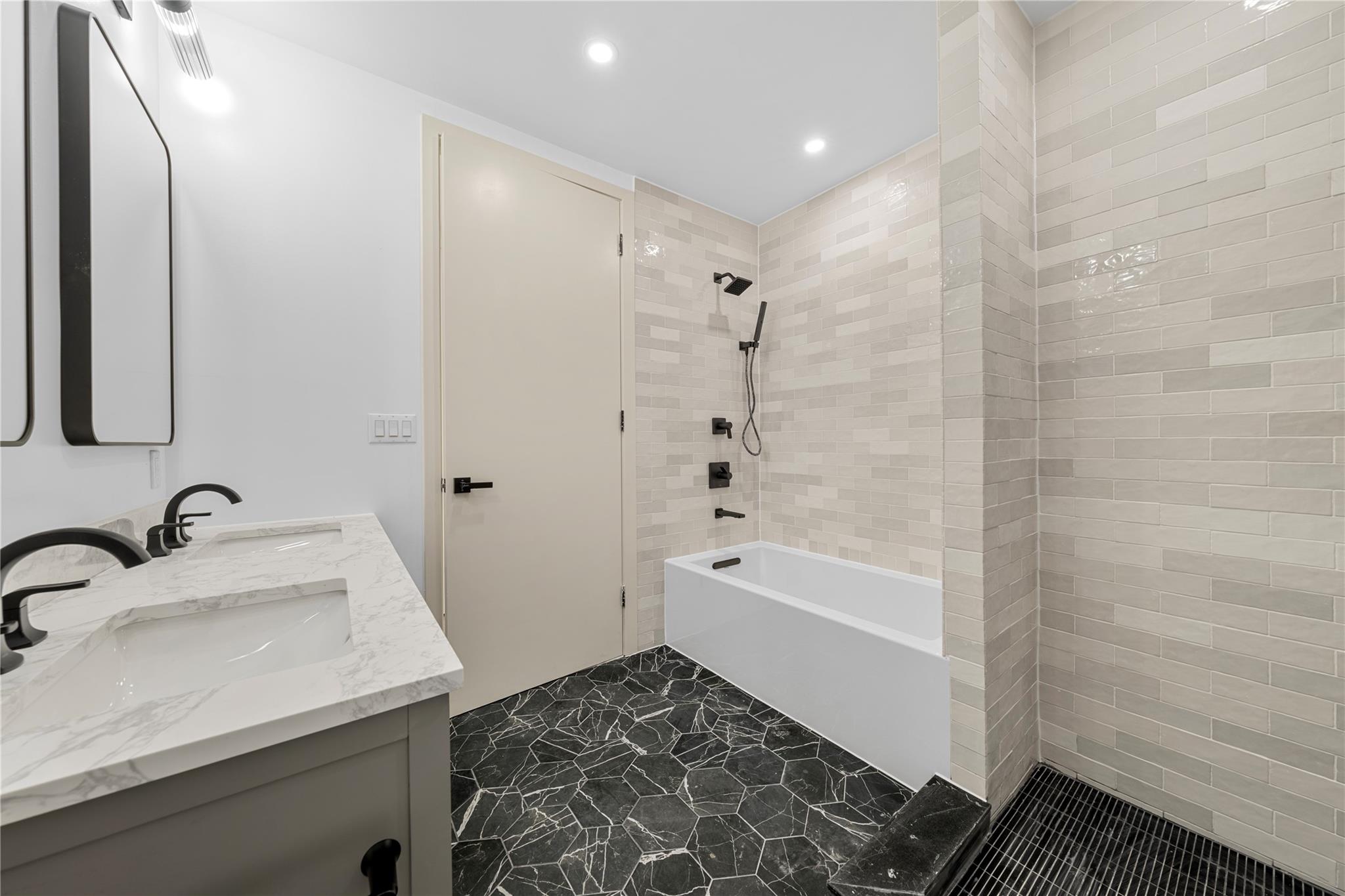 312 Fenimore Street Brooklyn, NY 11225 - Photo 19 of 37 Full bath with double vanity, recessed lighting, shower / bath combination, and marble finish flooring