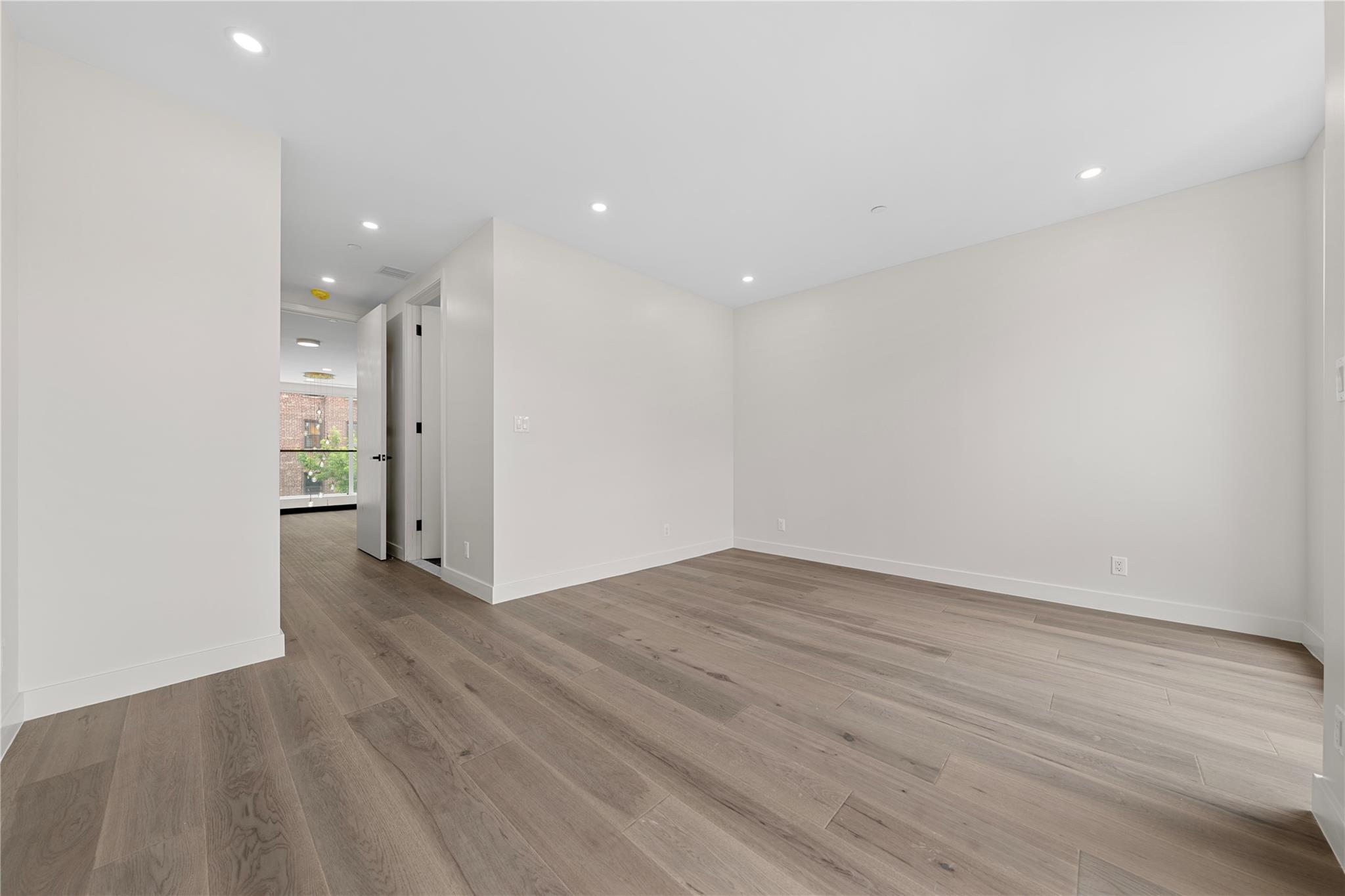 312 Fenimore Street Brooklyn, NY 11225 - Photo 21 of 37 Unfurnished room featuring light wood-style floors, baseboards, and recessed lighting