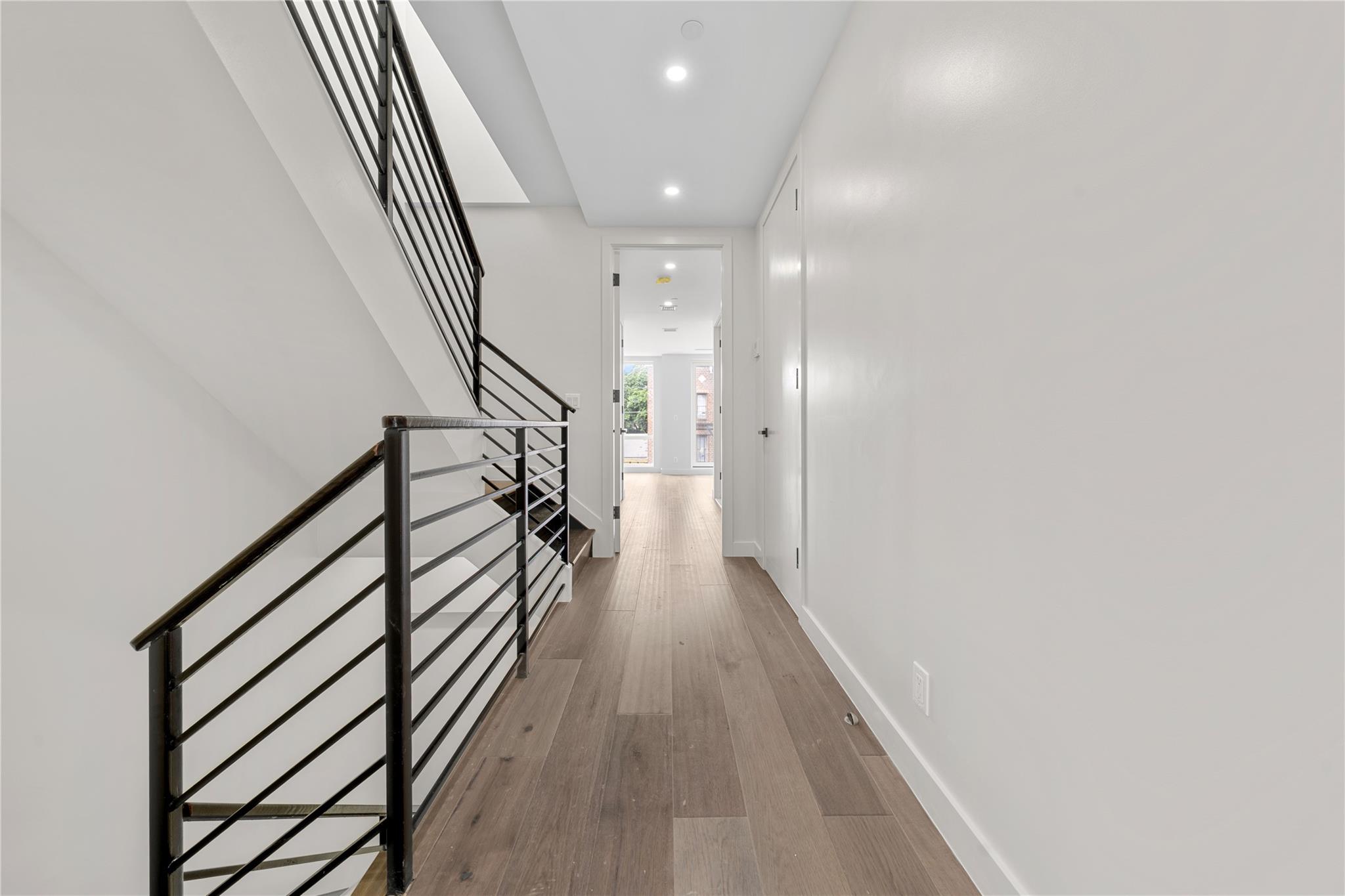 312 Fenimore Street Brooklyn, NY 11225 - Photo 26 of 37 Hallway featuring recessed lighting, wood finished floors, stairs, and baseboards
