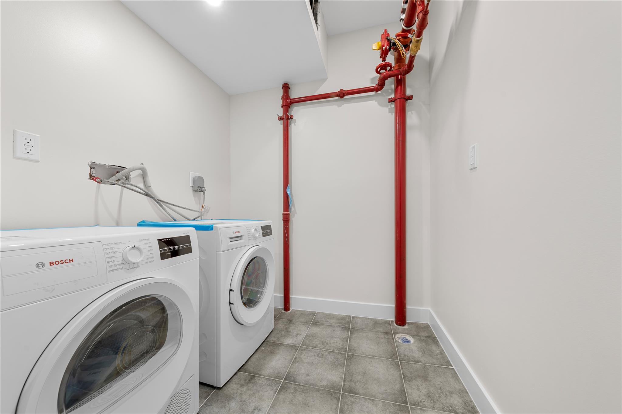 312 Fenimore Street Brooklyn, NY 11225 - Photo 30 of 37 Laundry room featuring independent washer and dryer and baseboards