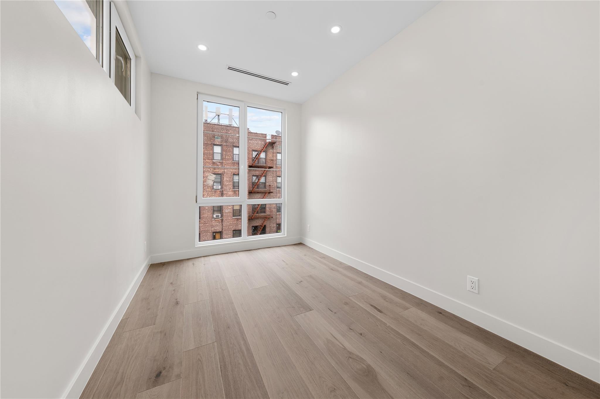 312 Fenimore Street Brooklyn, NY 11225 - Photo 32 of 37 Spare room featuring baseboards, light wood-style flooring, and recessed lighting