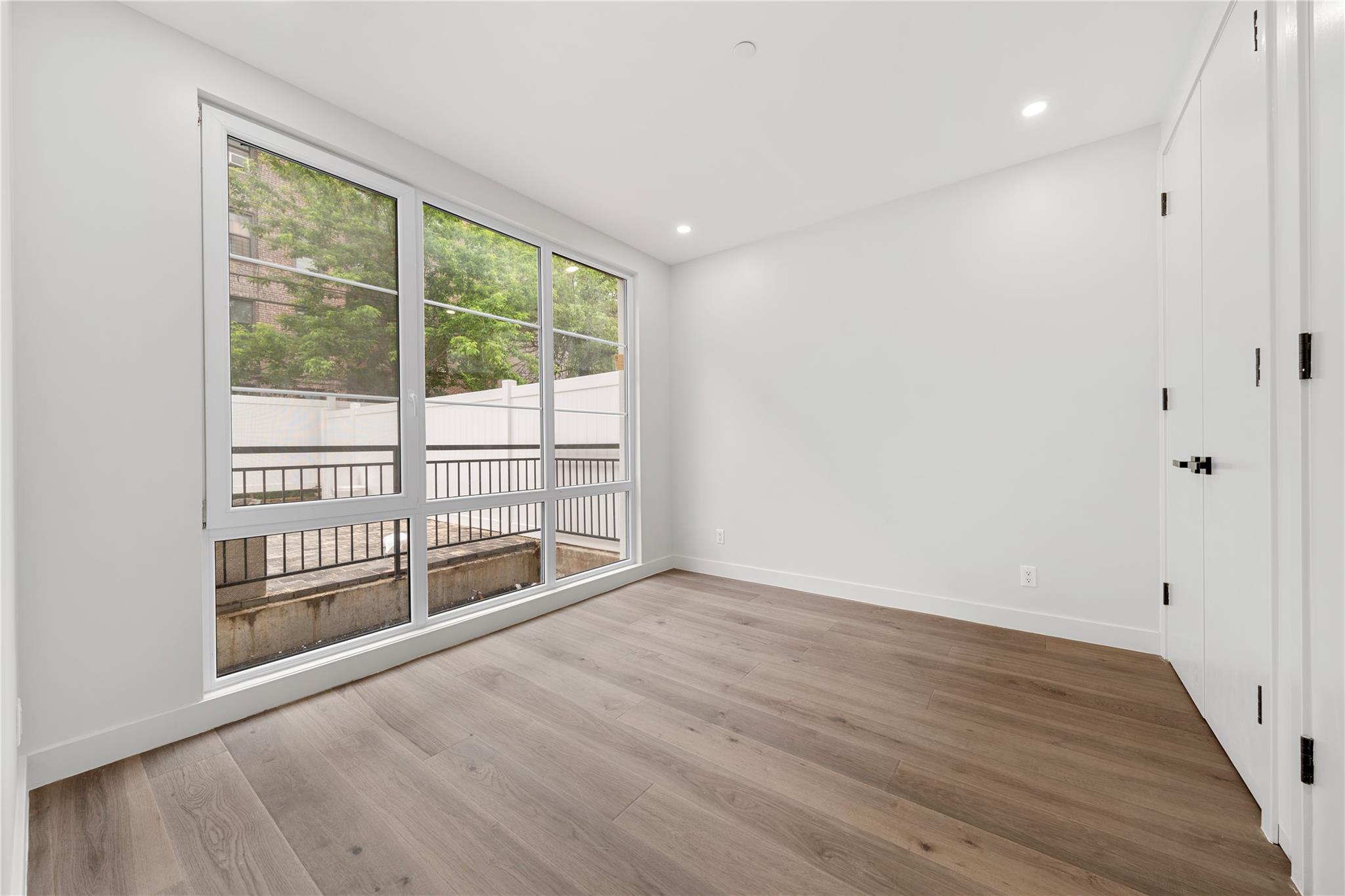 312 Fenimore Street Brooklyn, NY 11225 - Photo 9 of 37 Spare room with baseboards, wood finished floors, and recessed lighting