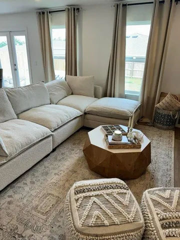 a living room with furniture and a large window