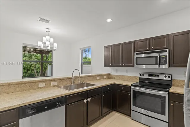 an aerial view of a house a yard and outdoor seating
