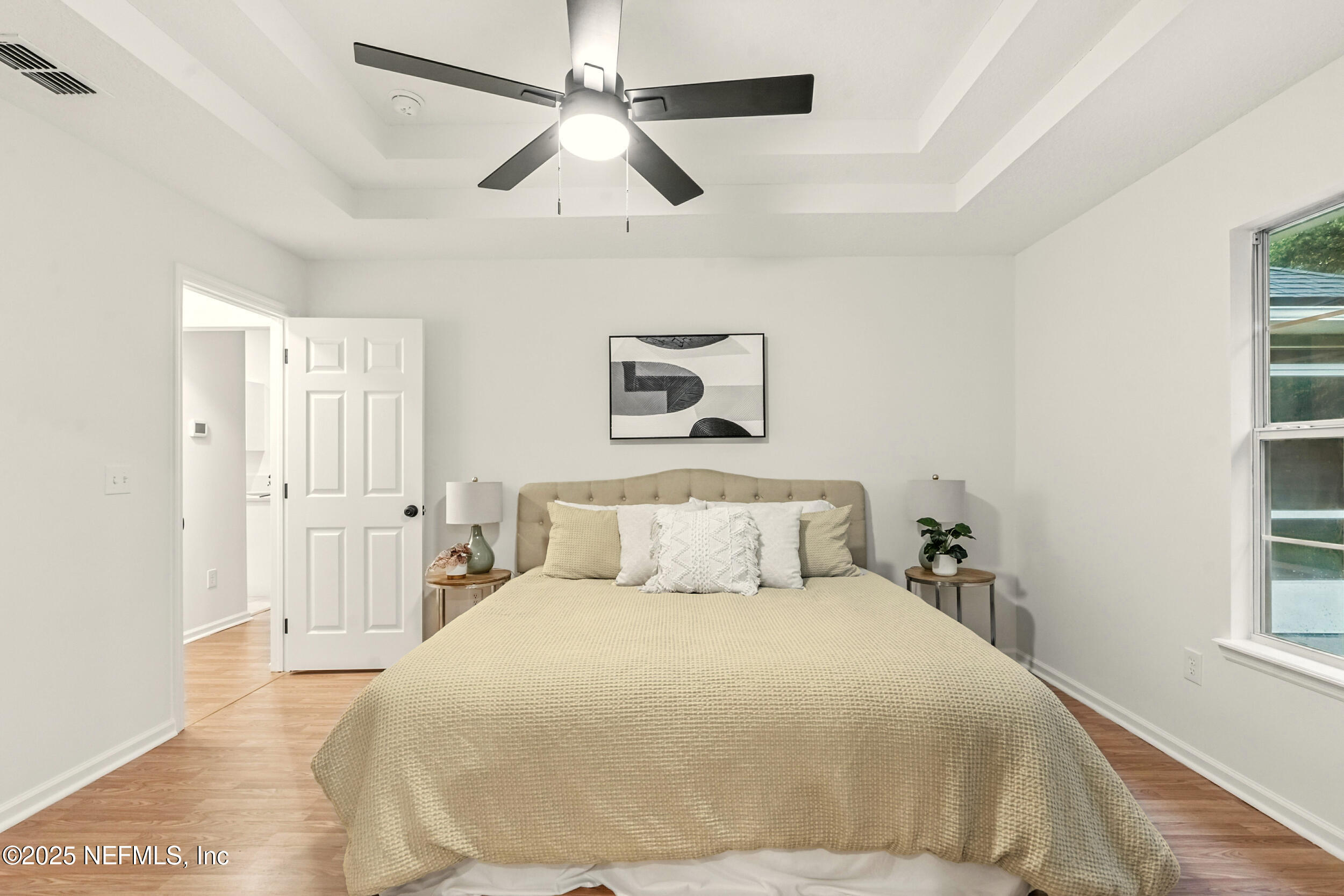 4385 Comanche Trail Boulevard St. Johns, FL 32259 - Photo 18 of 33 a bedroom with a large bed and a chandelier