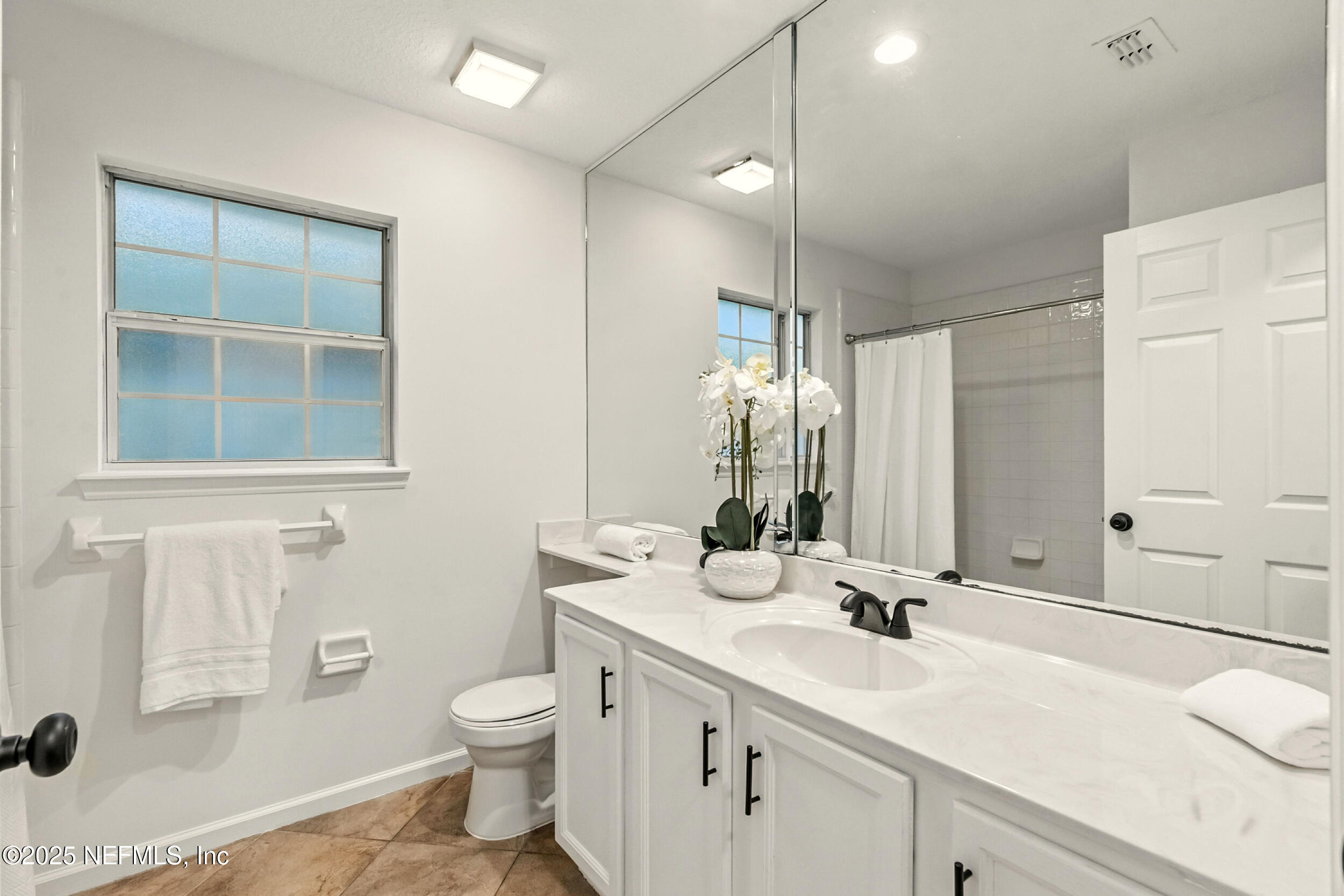 4385 Comanche Trail Boulevard St. Johns, FL 32259 - Photo 19 of 33 a bathroom with a toilet sink double vanity and mirror