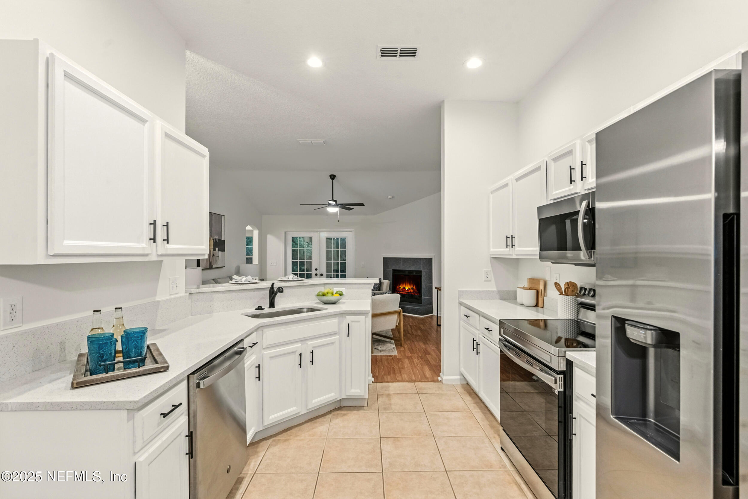 4385 Comanche Trail Boulevard St. Johns, FL 32259 - Photo 8 of 33 a kitchen with stainless steel appliances granite countertop a sink stove oven and refrigerator