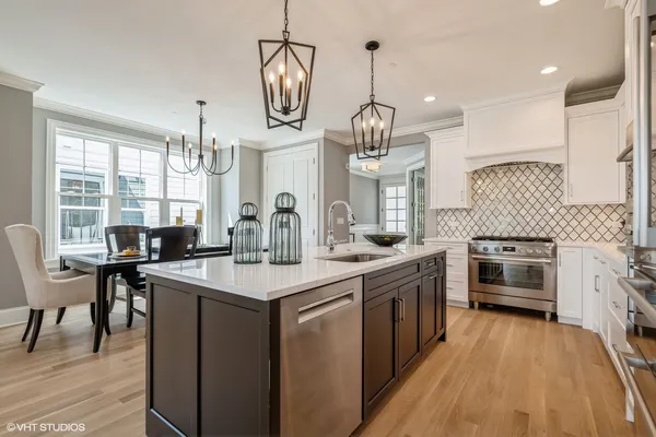 a kitchen with sink stove and cabinets