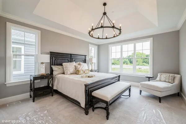 a bed room with a bed and a chandelier