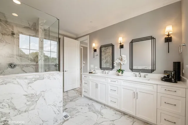 a bathroom with a double vanity sink mirror and shower
