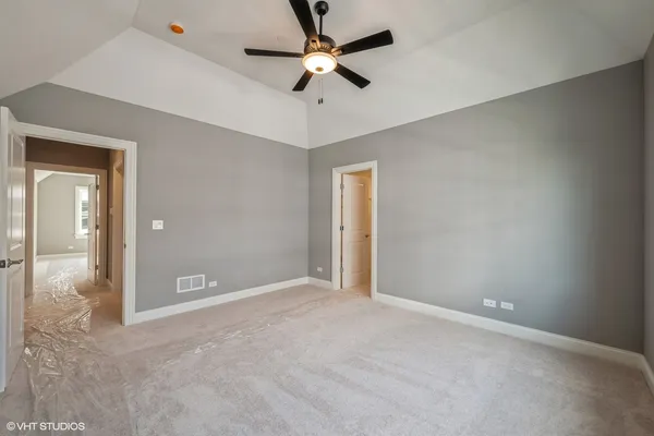 a view of an empty room and a ceiling fan