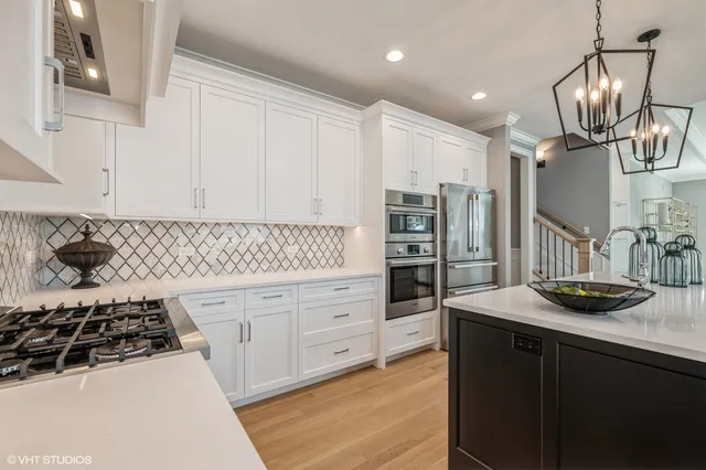 a kitchen with granite countertop a sink stove and cabinets