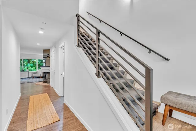a view of entryway and hall with wooden floor