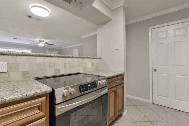 a stove top oven sitting inside of a kitchen