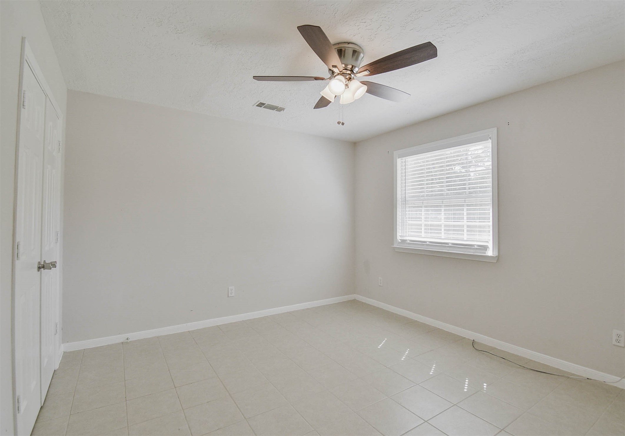 3 Magnolia Lane, Unit 1 Huffman, TX 77336 - Photo 14 of 23 an empty room with a window and a fan
