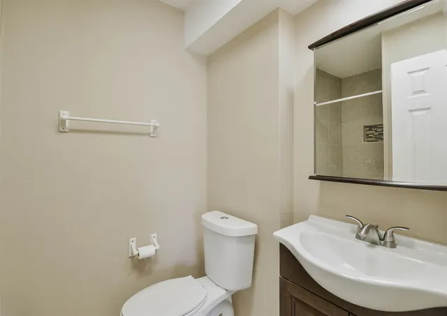 a bathroom with a sink a toilet and mirror