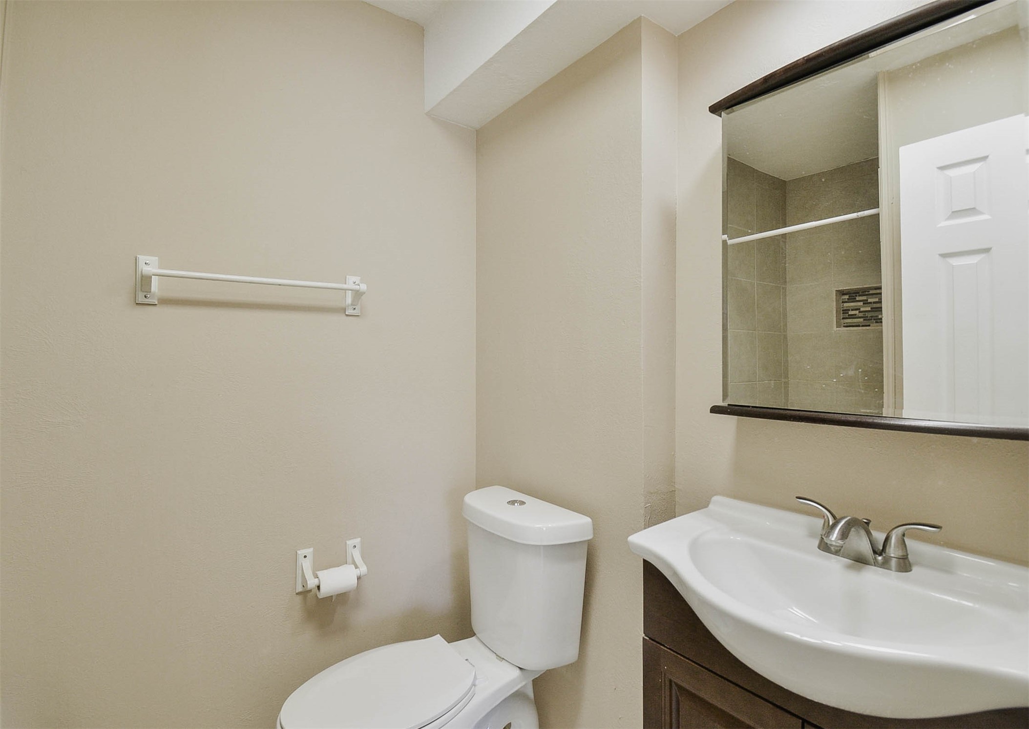 3 Magnolia Lane, Unit 1 Huffman, TX 77336 - Photo 19 of 23 a bathroom with a sink a toilet and mirror