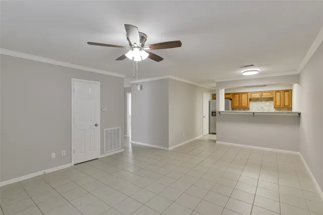 a view of a livingroom with a ceiling fan and entryway