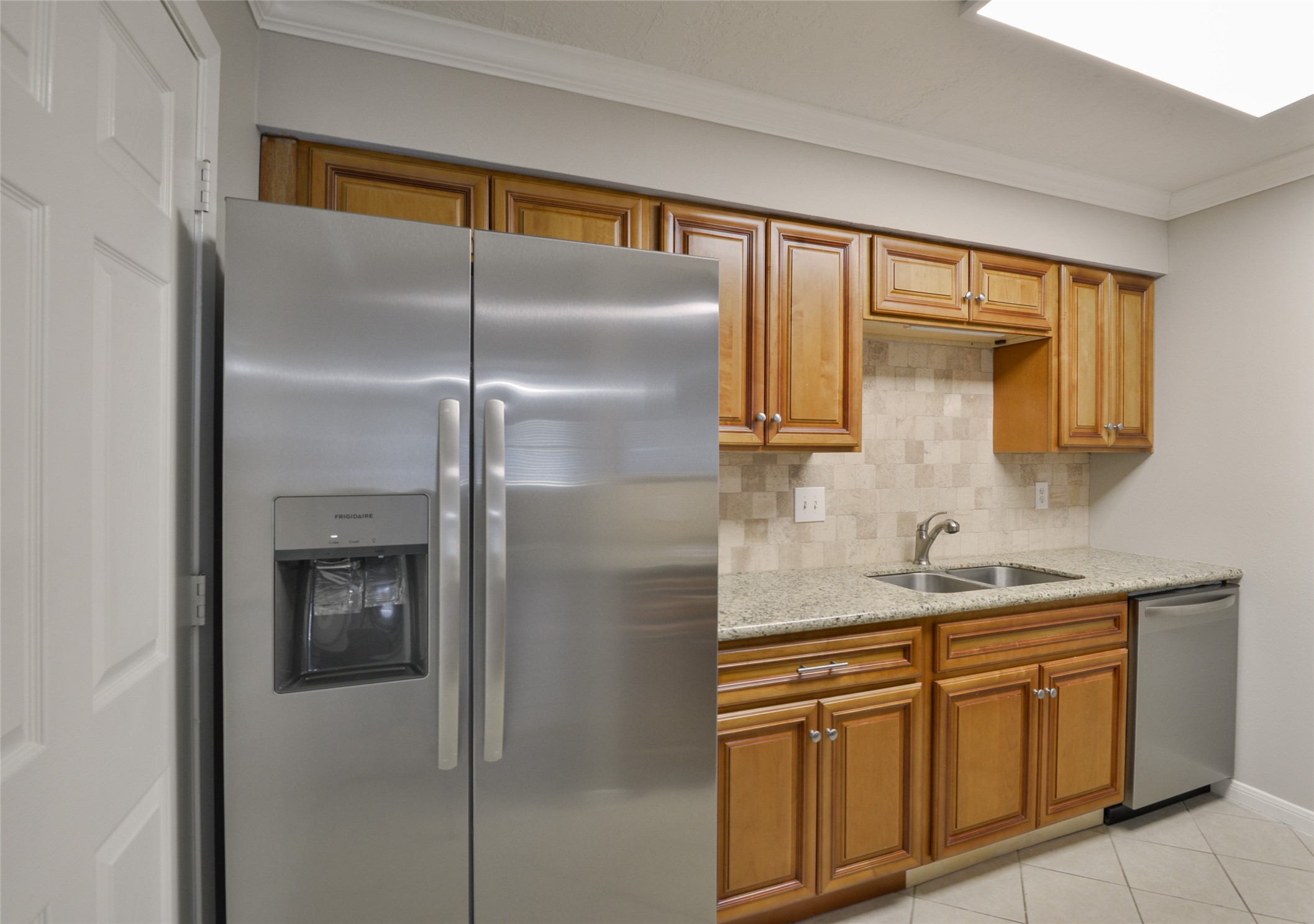 3 Magnolia Lane, Unit 1 Huffman, TX 77336 - Photo 8 of 23 a kitchen with a sink and refrigerator