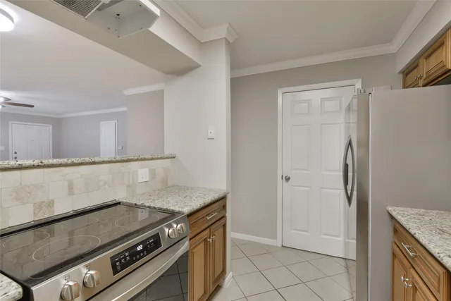a view of a kitchen counter space and stove top oven
