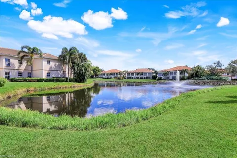 a view of a lake with houses in the back