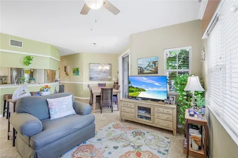 a kitchen with stainless steel appliances granite countertop a sink a stove a dining table and chairs