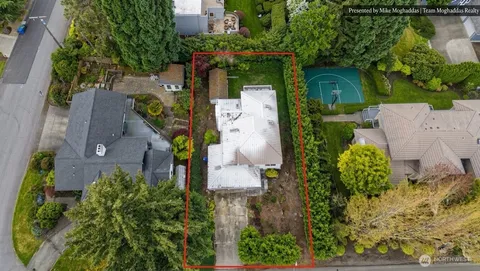 an aerial view of a house with outdoor space and a lake view